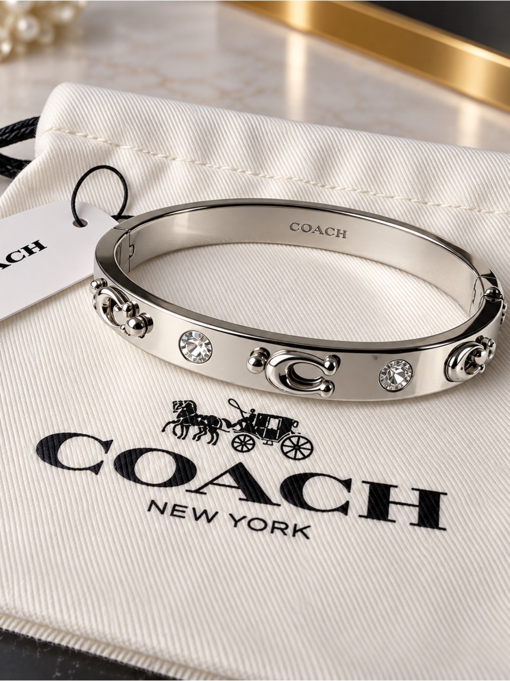 COACH Polished Silver Crystal Accent Bangle Bracelet